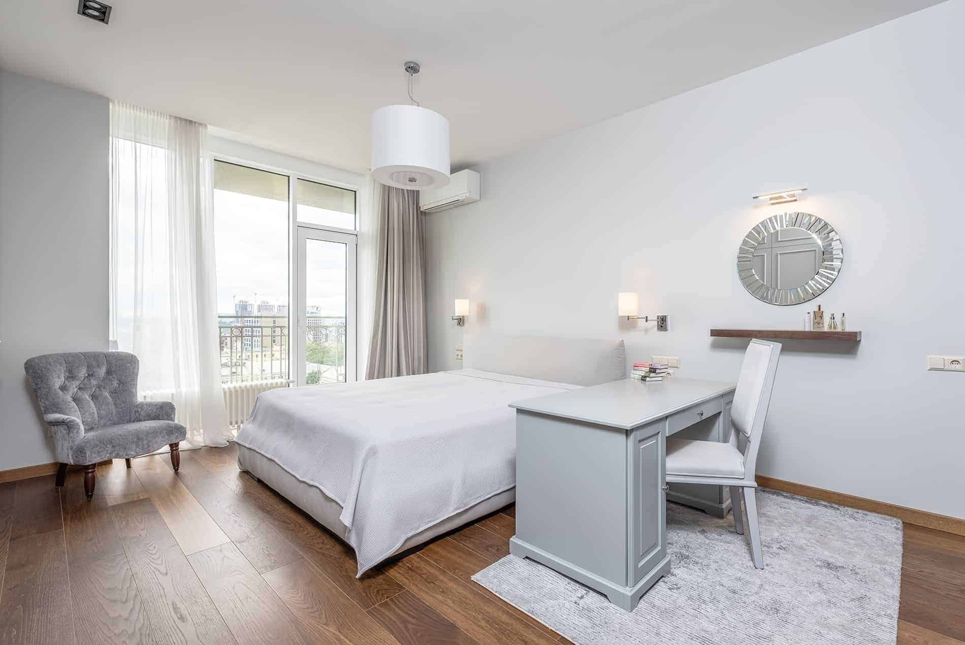 A bright bedroom with a desk
